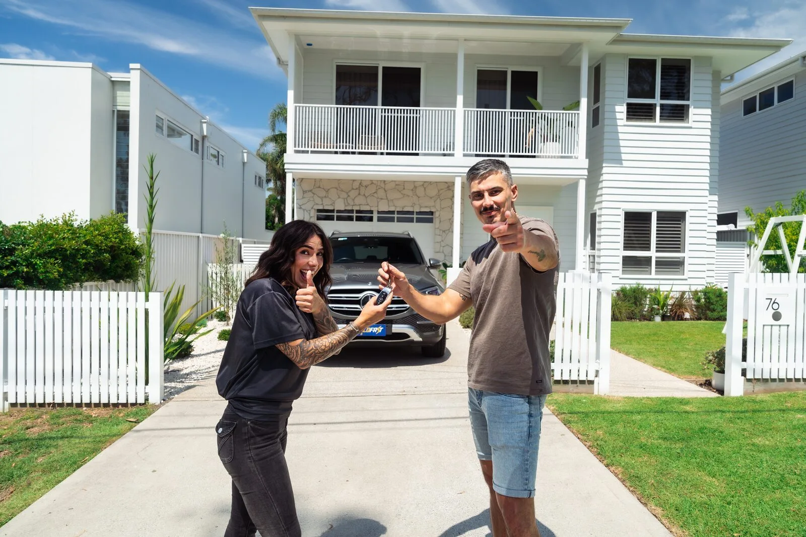 Sold Fast team member handing car keys to a happy seller at their home in Sydney